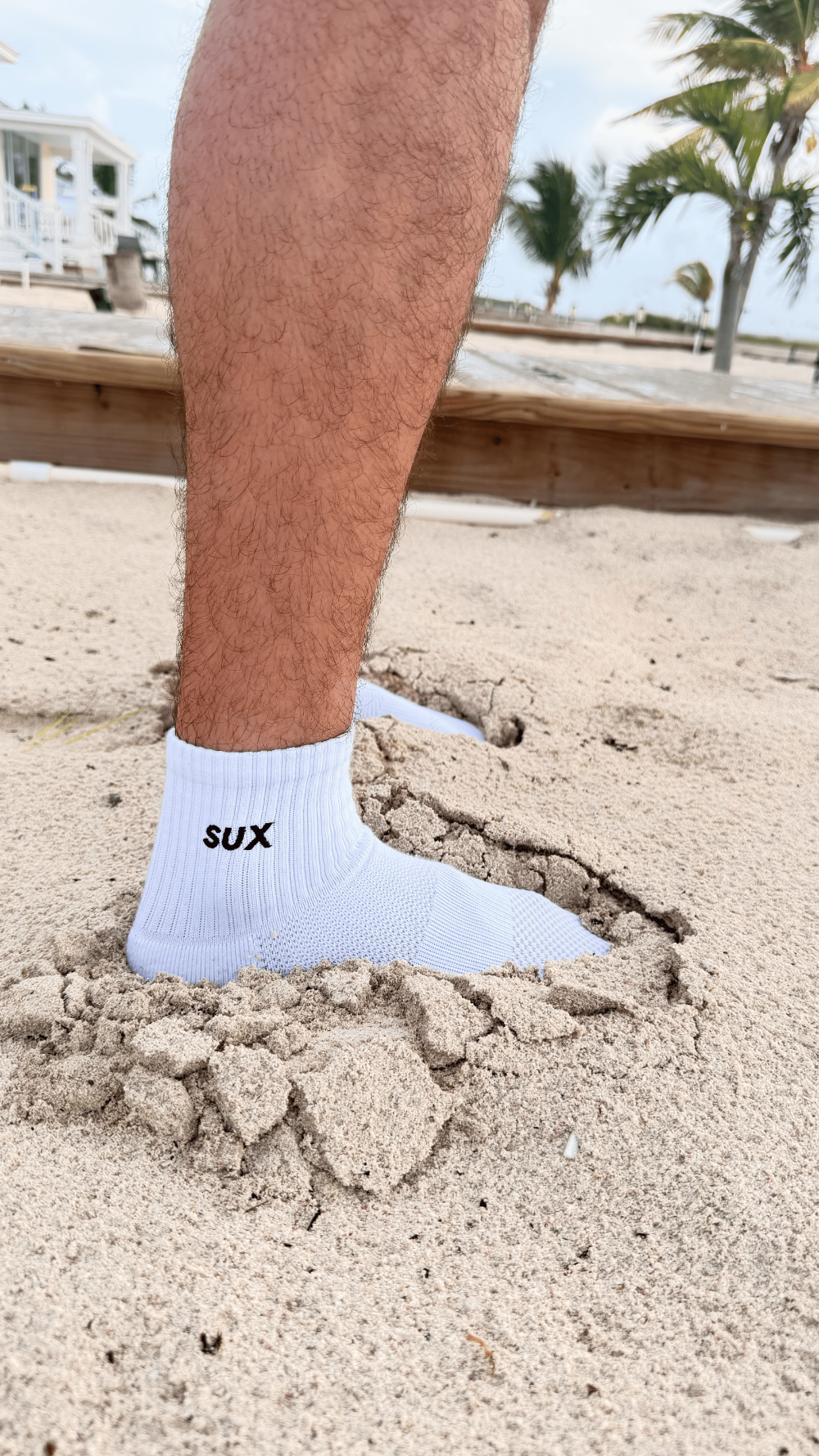 SUX socks worn on the beach